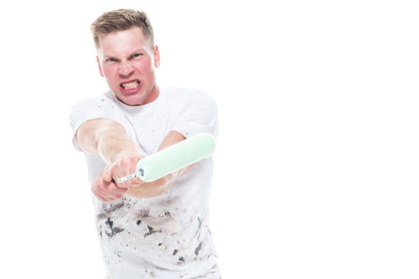 istock Handsome male painter attacking with his tool in his hand 1144002908