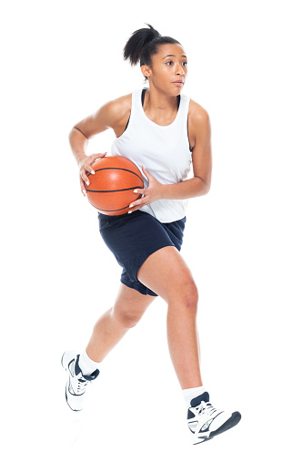 Attractive African American female playing basketball