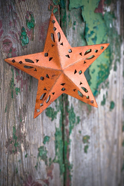 istock Rusty christmas star on rustic old door shallow dof 114400585
