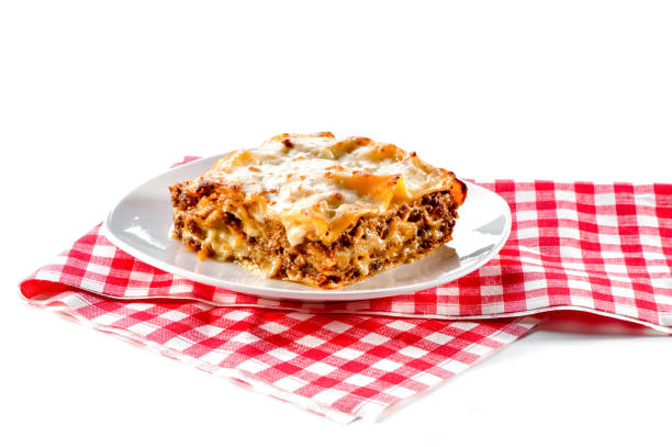istock lasagna with plate and checkered red napkin isolated on white background 1144023532