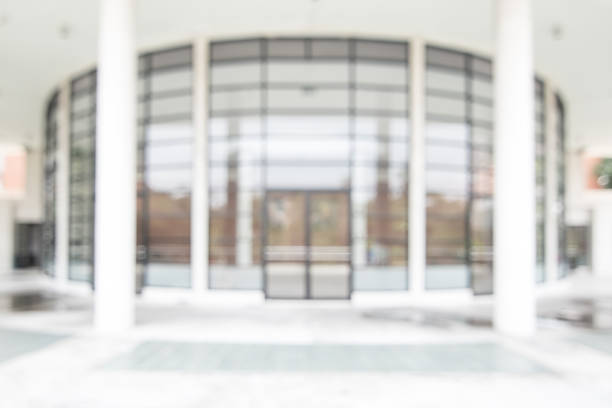 istock Office or university building blur background exterior view with blurry empty lobby space, entrance hall glass wall window and light bokeh 1144031721