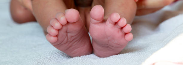 istock Cute little baby feet on a bed 1144033734