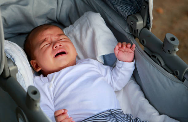 istock Cute newborn baby boy crying in a stroller 1144043955