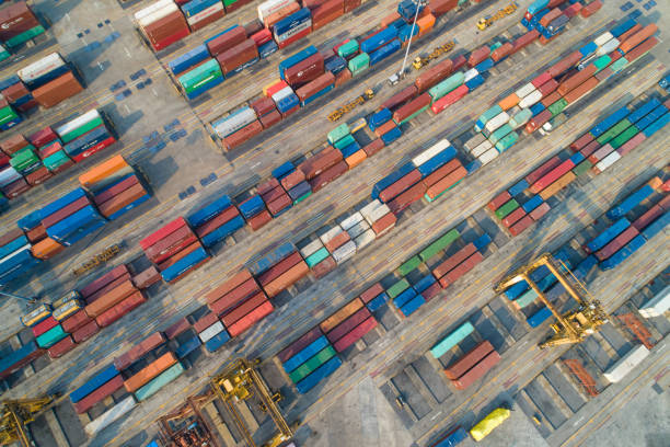istock Logistics and transportation of Container Cargo ship and Cargo with working crane bridge in shipyard at sunrise, logistic import export and transport industry background 1144051066