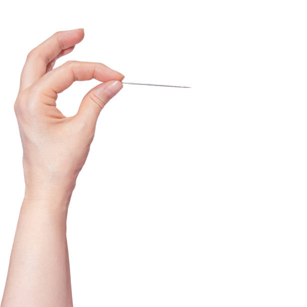 Woman's hand holding a needle on white background. Woman's hand holding a needle on white background sewing needle stock pictures, royalty-free photos & images