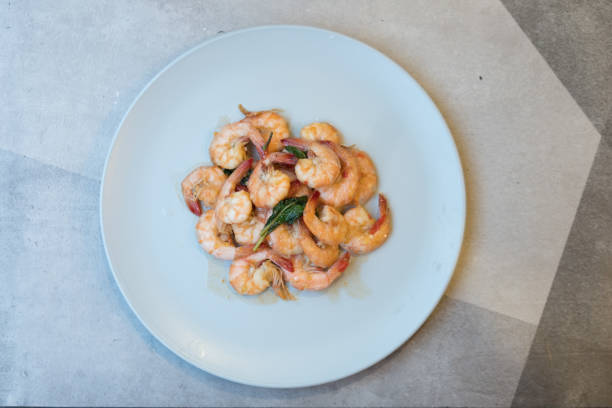 istock Spicy fried shrimp with basil leaves, Thai style food 1144065638
