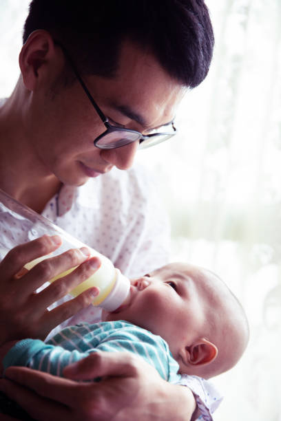 istock Father feeding newborn baby son 1144065877