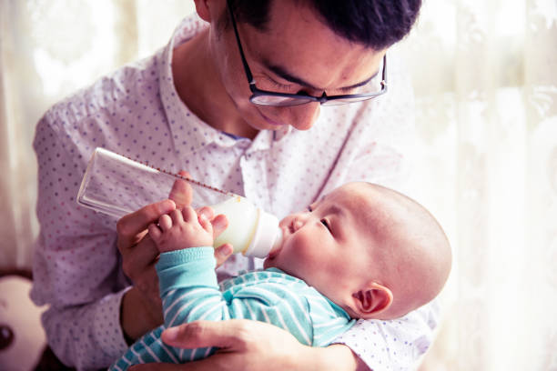 istock Father feeding newborn baby son 1144065886