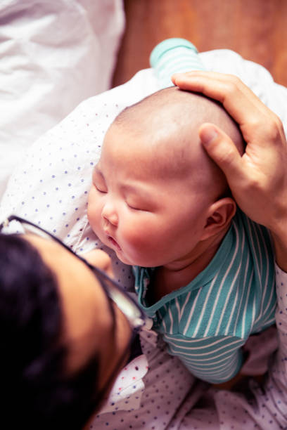 istock young father holding his newborn baby son sleeping 1144065944