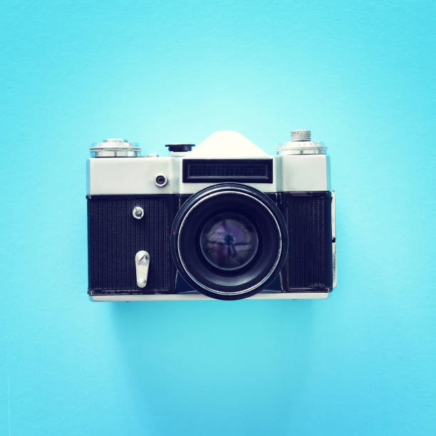 istock Top view of old photo camera over blue background 1144070428