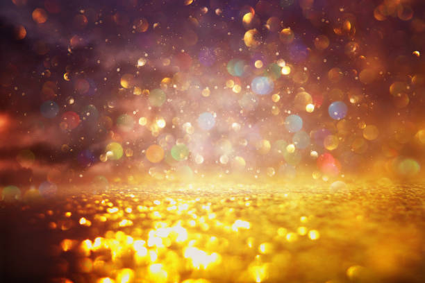 istock glitter vintage lights background. black and gold. de-focused 1144070437