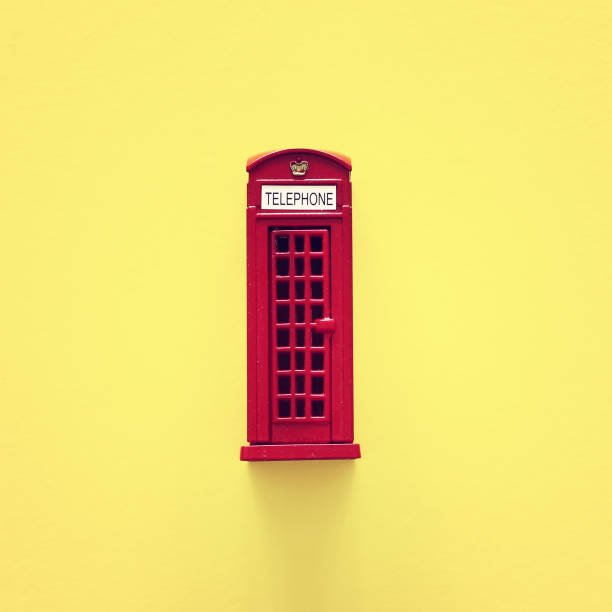 istock London traditional red phone booth over yellow background. 1144070464