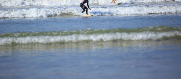 istock Two surfers riding waves in the ocean 1144072225
