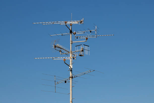 istock Televisions antennas with blue sky background 1144078133