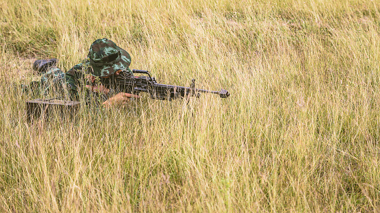 Army sniper military operation battle looking through the scope in the field