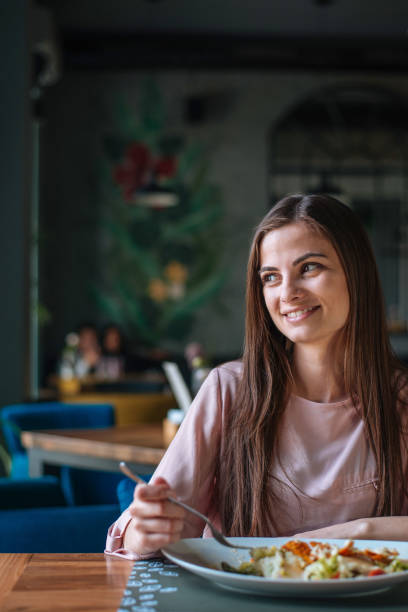 istock Young lady with long hair smiling and looking away 1144080714