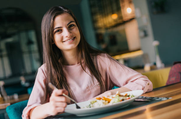 istock Cute young woman at the restaurant having lunch 1144080716