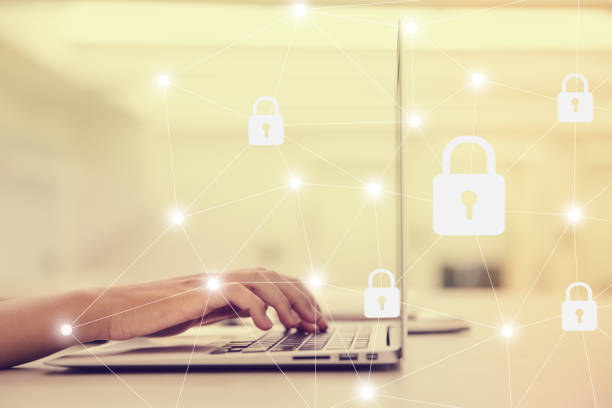 istock Select the icon security on the virtual display. Side view of female hand typing keyboard. 1144084284