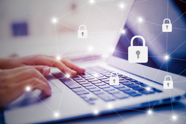 istock Select the icon security on the virtual display. Side view of female hand typing keyboard. 1144084290
