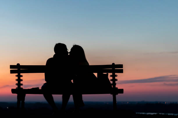 istock Couple sitting on the bench above horizon 1144085022