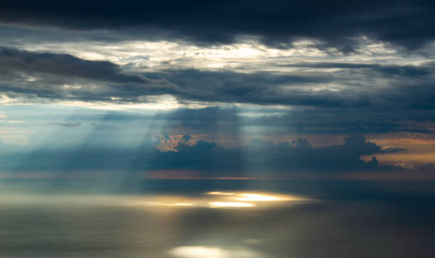 istock Rays of sunlight make their way through the clouds, illuminating the sea. 1144086645