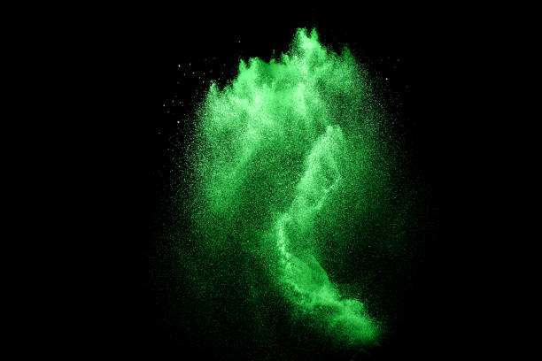 istock Green color powder explosion cloud  on black background.Green dust splash on dark background 1144089242