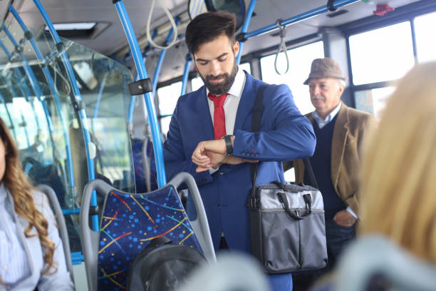 businessman riding on bus during rush hour - bus riding public transportation businessman imagens e fotografias de stock