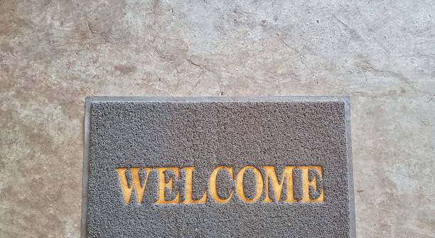 istock Front door with doormat plants with welcome written on it 1144090468