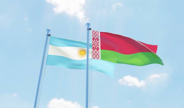 istock Argentina and Belarus, two flags waving against blue sky 1144107377
