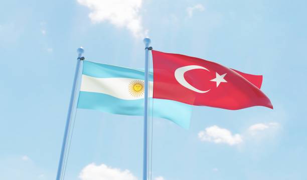 istock Argentina and Turkey, two flags waving against blue sky 1144108362