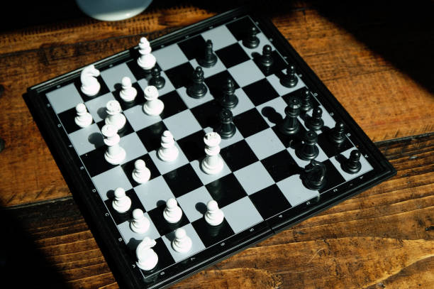 istock Strategy chess battle intelligence game on chessboard. Success the chess strategy concept. Chess business leader and success idea. Chess set photographed on a chess board on a wooden background. 1144109483