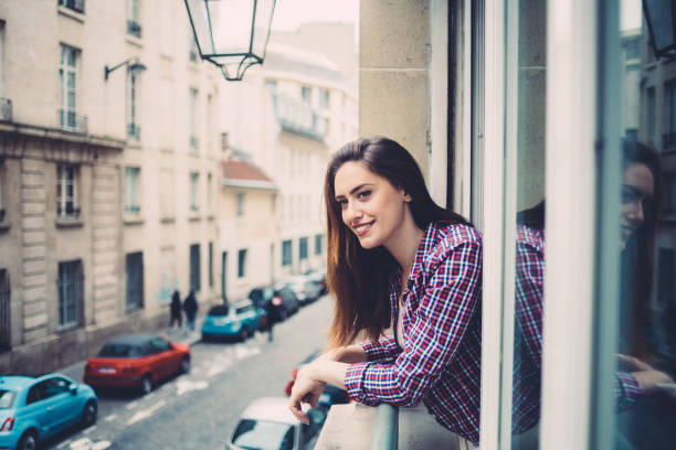 istock Relaxed woman on the window in Paris 1144110233