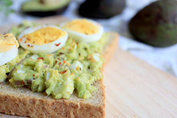 istock Avocado and egg toast on wooden. close up. 1144113357