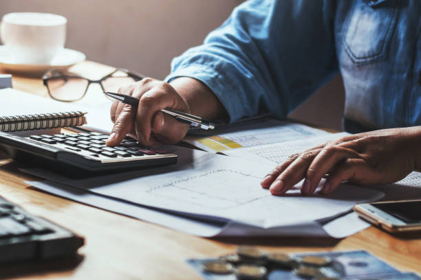 istock businesswoman working with using calculator in office 1144114560