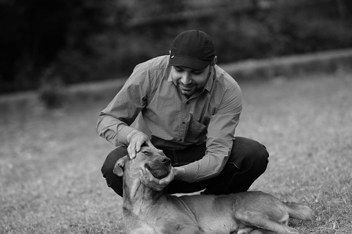 Young men with a young dog outdoors in the nature.