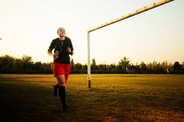 istock Happy female soccer player running 1144115502