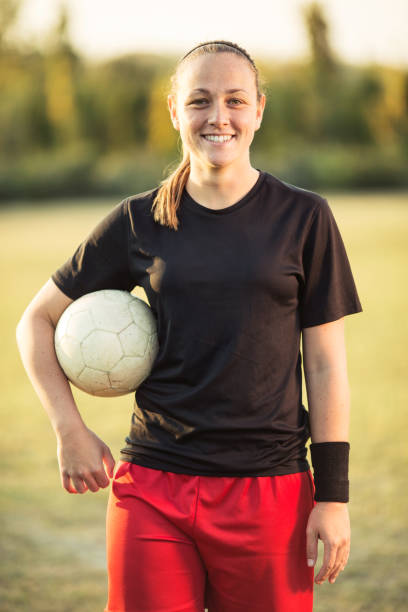 istock Young female soccer player posing with soccer ball 1144115542