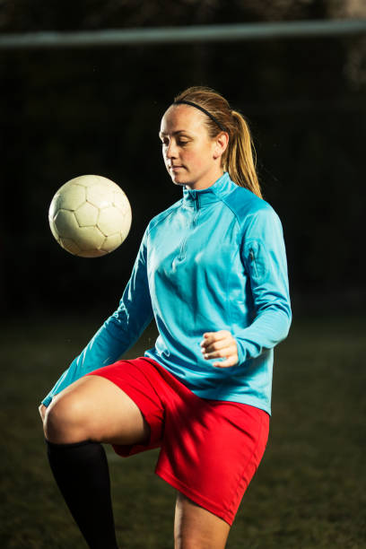 istock Young woman playing soccer 1144116543