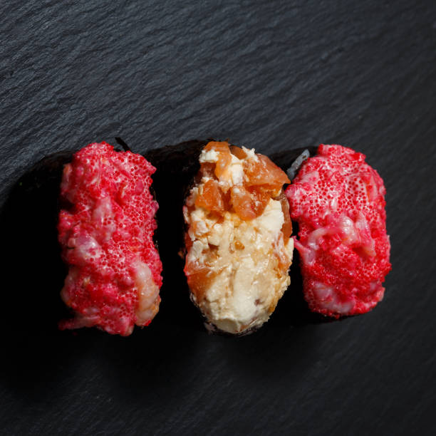 istock Juicy Gunkan Maki Sushi on black slate 1144116643