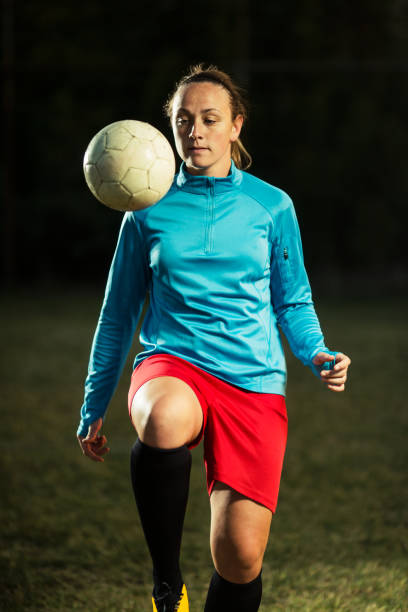 istock Young woman playing soccer 1144116645