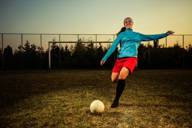 istock Female soccer player outdoors hitting a ball 1144116999