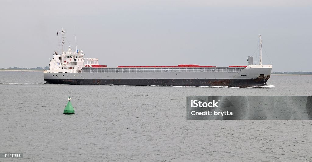 Cargo ship sailing on Eastern Scheldt,Zeeland,the Netherlands Freight transport on the Eastern Scheldt,Netherlands. Buoy Stock Photo