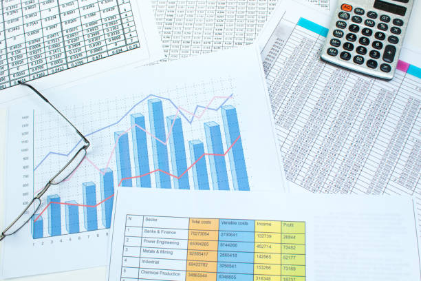 istock Financial printed paper charts, graphs and diagrams on the table. Top view 1144120181