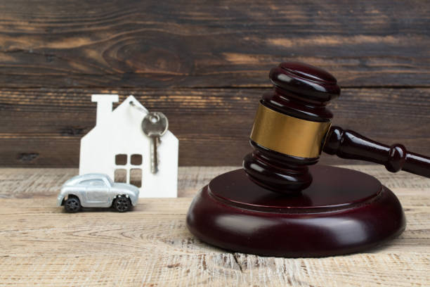 wooden house, car judge's gavel on wooden background. purchase, sale of real estate. housing. stock photo