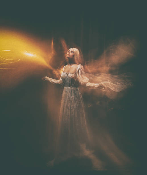 The legend of the Banshee fairy. Pale girl blonde, like a ghost, in a white vintage dress, flies, hovers in space. girl night butterfly, light angel with wings of floating fabric. Artistic photo