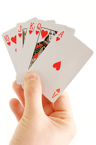 istock Hand holding Poker cards Royah flush isolated against white 114412730