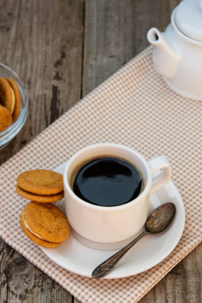 istock Cup of coffee with sweet cookies, ginger bread. Abstract breakfast image. Rustick wooden background. 1144127982