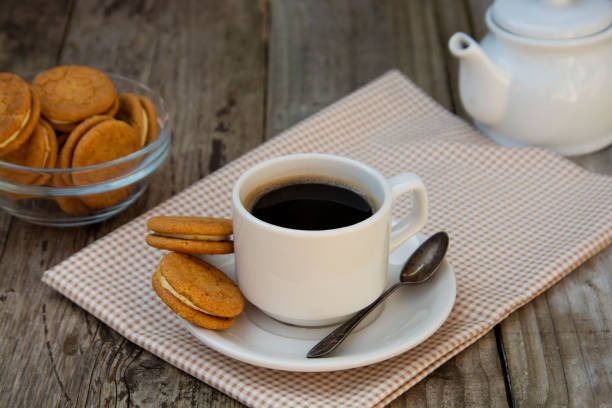 istock Cup of coffee with sweet cookies, ginger bread. Abstract breakfast image. Rustick wooden background. 1144128366