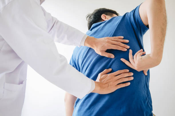 istock Doctor physiotherapist treating lower back pain patient after while giving exercising treatment on stretching in the clinic, Rehabilitation physiotherapy concept 1144130937