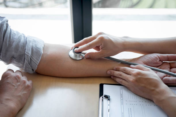 istock Doctor using a stethoscope checking patient with examining, presenting results symptom and recommend treatment method, Healthcare and medical concept 1144131002